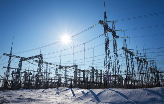 High voltage power lines in the winter. Thermal power plant. High-voltage transformer substation.