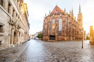 Street view on the saint Sebaldus cathedral during the sunset in Nurnberg city, Germany - obrazy, fototapety, plakaty
