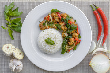 Crispy chicken cooked with sweet basil eat with rice.it is a very delicious Thai food.
