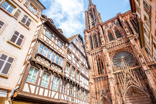 Street view from below on the beautiful old buildings and Notre-Dame cathedral in Strasbourg city, France
