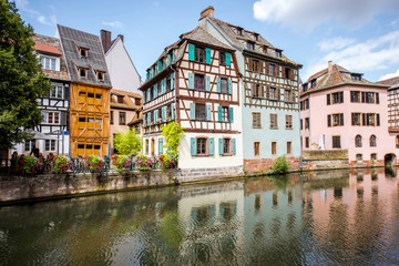 Fototapeta na wymiar Landscape view on the water channel with beautiful half-timbered houses in Strasbourg city, France