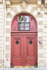 Fototapeta premium Paris, beautiful wooden red door, girder with sculptures 