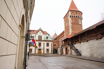 Krakow street, ancient tower building and city walls, Poland
