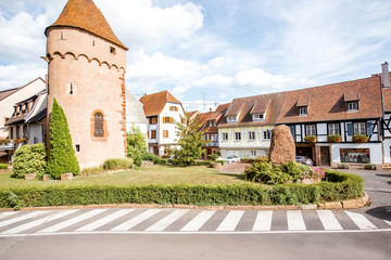 Old castle tower in Obernai town during the sunny weather in Alsace region, France