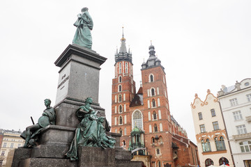 Fototapeta premium St. Mary's basilica and Adam Mickiewicz monument in Krakow Market Square, Poland