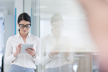 Business Woman Using Digital Tablet in front of startup Office