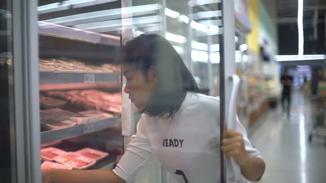 Young Asian Woman buying minced meat in supermarket 4k UHD (3840x2160)
