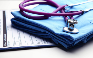 Doctor coat with medical stethoscope on the desk