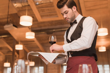 waiter serving wineglasses on table