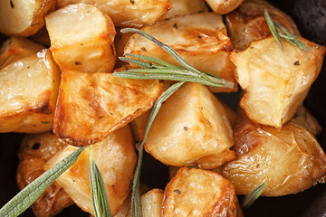 Delicious baked potatoes with rosemary, closeup