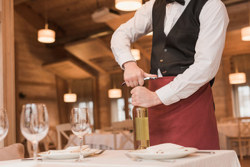 waiter opening bottle of wine