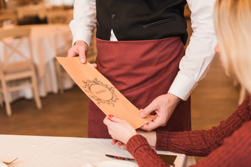 Waiter giving menu - obrazy, fototapety, plakaty