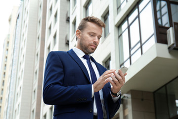 Fototapeta premium Attractive man in formal suit on city street