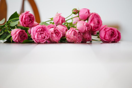 Image of pink flowers on white wooden table