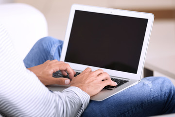 Young man using laptop at home
