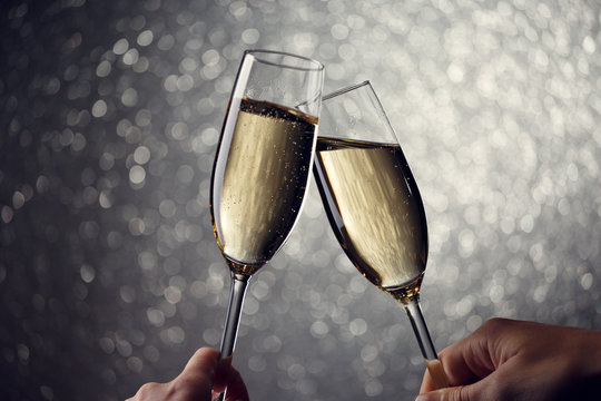 Picture of two glasses with champagne on gray background