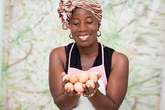 young smiling woman holding eggs