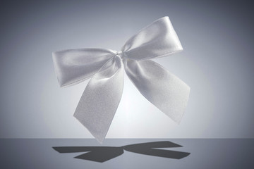Ribbon on gray background with shadow. 