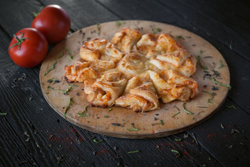 cheese cake on a wooden board with spices and tomatoes