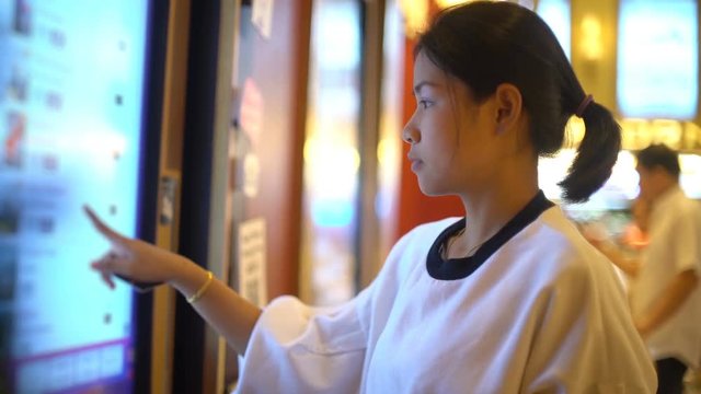 Young Asian Woman using tickets machine in cinema 4k UHD (3840x2160)
