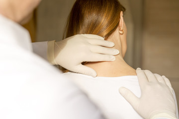 Chiropractor doing adjustment on female patient due to neck pain