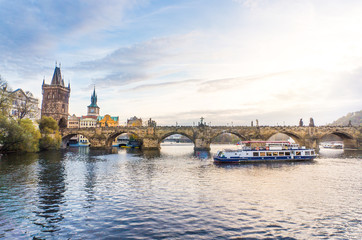 Fototapeta na wymiar Charles Bridge and a boat cruise in Vltava river in Prague, Czech Republic.