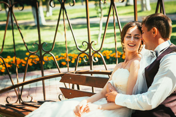 the bride and groom in the gazebo in the park