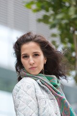 Portrait of a beautiful girl in an urban landscape in autumn