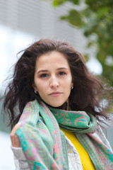 Portrait of a beautiful girl in an urban landscape in autumn