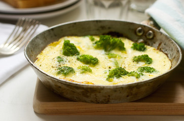 Omelette with broccoli and cheese served with bread toasts and lemonade.