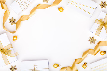 christmas or new year frame composition. christmas decorations in gold colors on white background with empty copy space for text. holiday and celebration concept for postcard or invitation. top view