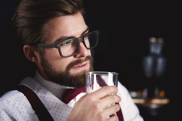 Lonely business person tasting whiskey
