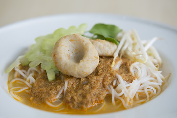 COCONUT CURRY WITH RICE NOODLE
Coconut fish curry with rice noodle served with white enamel plate. Popular thai street food. 