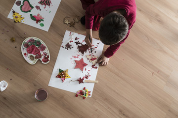 A kid doing Christmas painting decorations