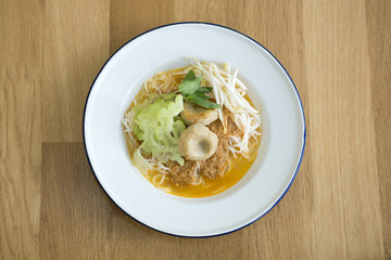 COCONUT CURRY WITH RICE NOODLE
Coconut fish curry with rice noodle served with white enamel plate. Popular thai street food. 