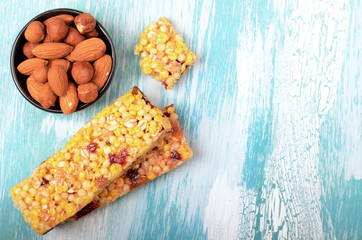 Muesli bars with nuts on wooden background