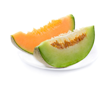 melon slices in white plate isolated on white background