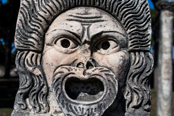Marble Mask decoration in Ostia Antica theatre. Ancient Rome 1st century mask in the proscenium of Ostia antica, part of architectonic decoration