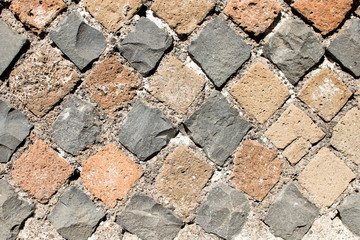 Detail of perimeter wall of a house of ancient Rome with the layout of the brickwork that follows the technique of Opus Reticolatum