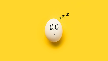 Painted chicken egg with sleeping emoji