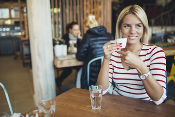 Beautiful woman drinking coffee in cafe