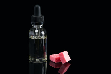 liquid in bottles with taste candy, concept on black background with reflection