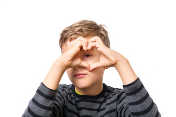 young blonde boy make a heart with his hands and fingers