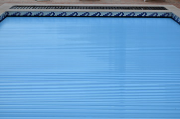 Electric slatted Swimming Pool cover on home swimming pool