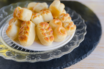 Spanish Christmas marzipan sweets, Figuritas de in black plate on wooden table. Traditional treat consumed during winter holidays in Spain.