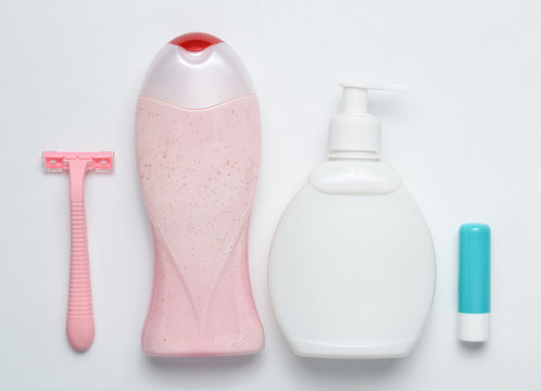 Products for hygiene and body care layout on a white background. Soap, shampoo, toothbrush, razor, lipstick. Top view.