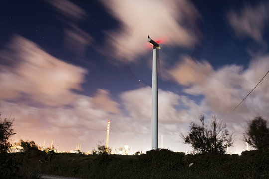 Windmill at night and cloudy sky