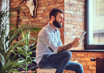 A man using tablet PC in a room.