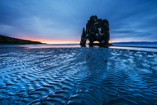 Hvitserkur 15 m height. Is a spectacular rock in the sea on the Northern coast of Iceland. On this photo Hvitserkur reflects in the sea water after the midnight sunset