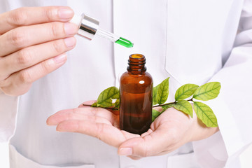 Scientist with natural drug research, Green herbal medicine discovery at science lab. (Selective Focus)